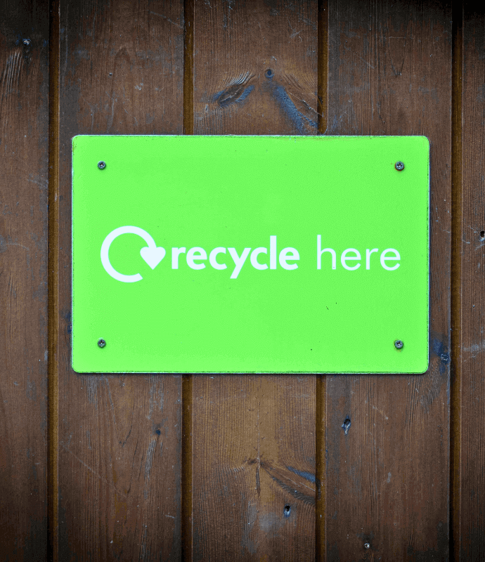Vibrant green Recycle Here sign on wall