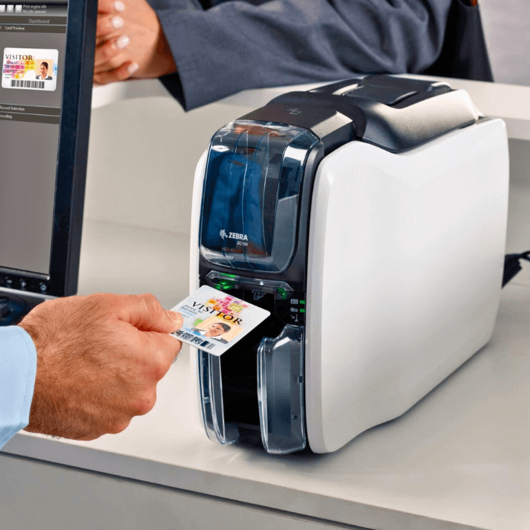 Zebra ZC100 ID Card Printer pictured with a visitor card