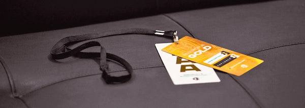 Two custom printed event passes attached to a black lanyard, ideal for festivals
