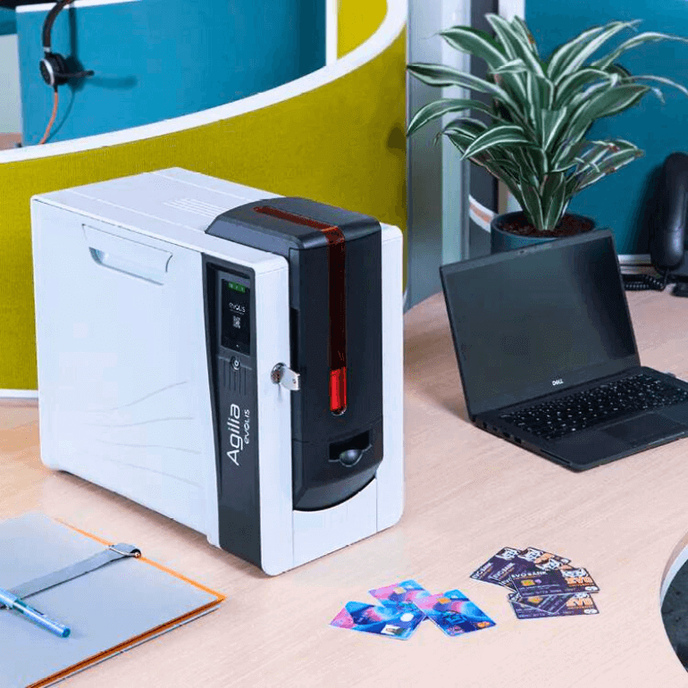 Evolis Agilia ID Card Printer on desk next to laptop