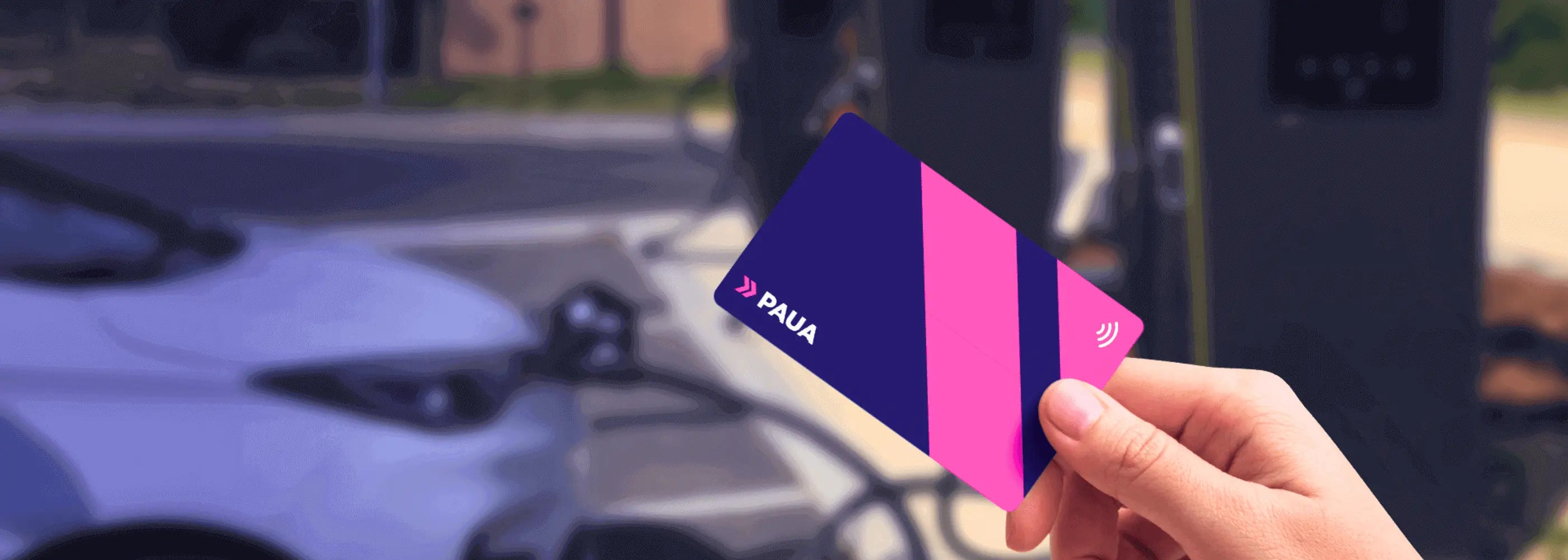 Paua Custom Printed EV Charge Card being held up in front of an electric vehicle