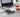 Person Programing blanks white card holding it against a card reader hooked up to the laptop