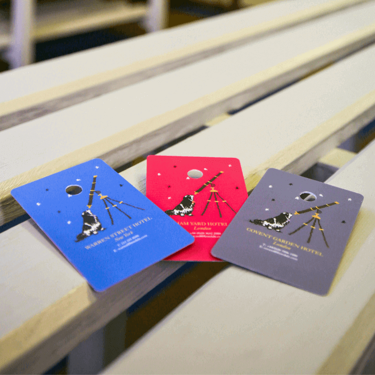 Warren Street Hotel custom printed cloakroom tags pictured on a bench
