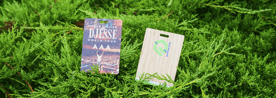 Custom Printed Sustainable Event Passes for Jacob Collier and The Quantam Show pictured on top of greenery