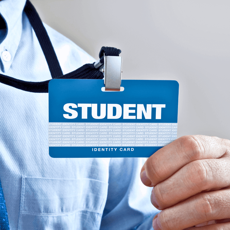 Student holding up an ID card with Student and Identity Card printed