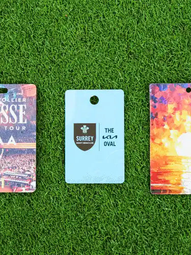 Sustainable Wood Biodegradable PVC and Paperboard event passes pictured on grass
